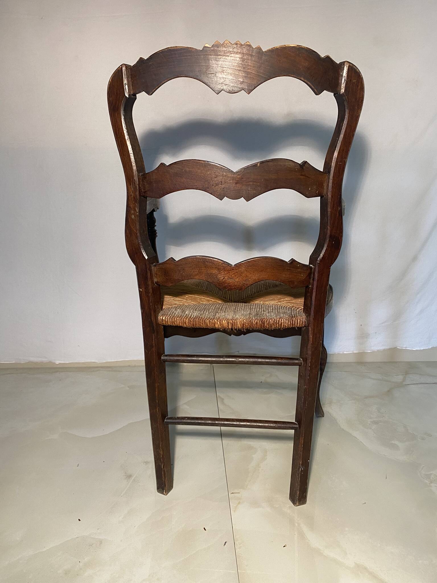 Antique Provencal armchair in carved wood with straw seat