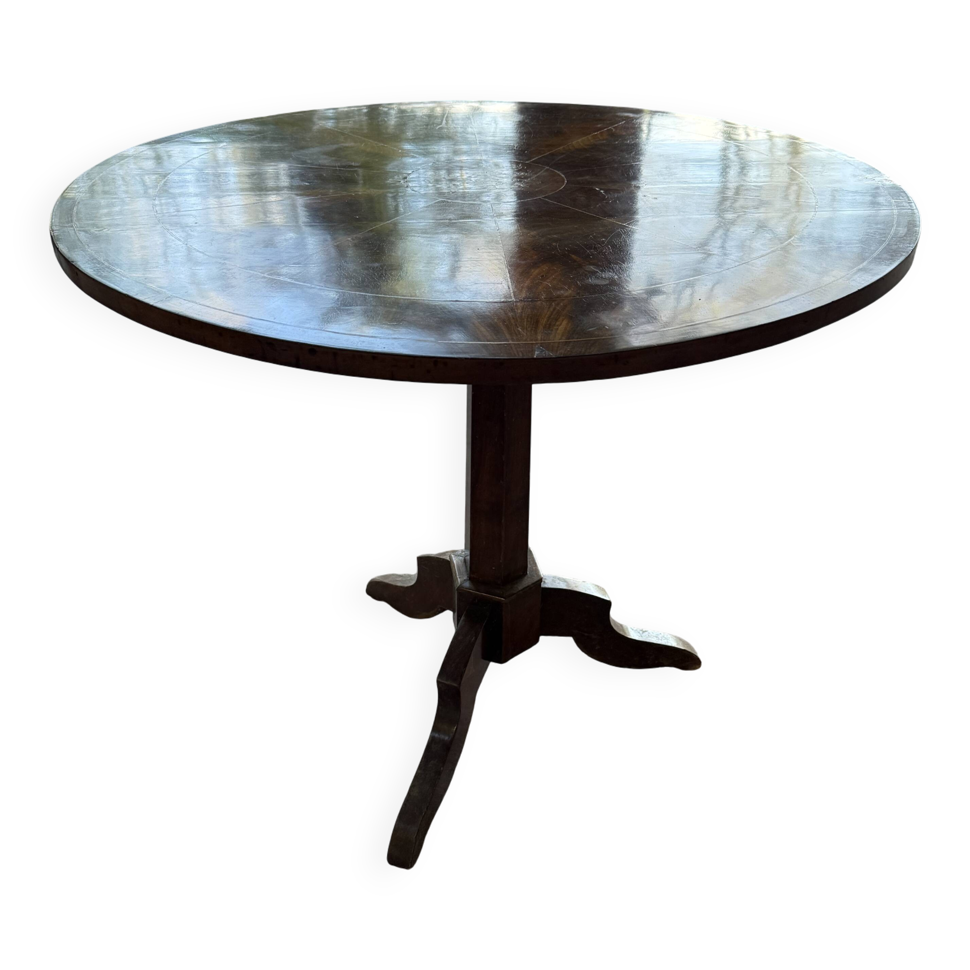 Antique round table with floral details.