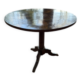 Antique round table with floral details.