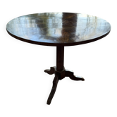 Antique round table with floral details.