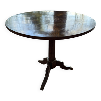 Antique round table with floral details.