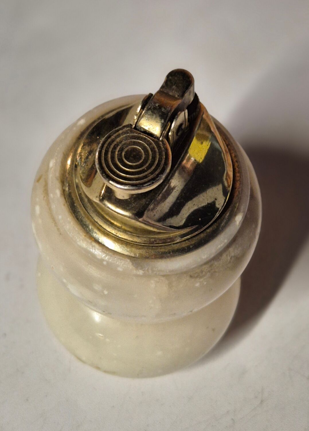 Vintage table lighter made of alabaster marble with a sculpted metal mechanism.