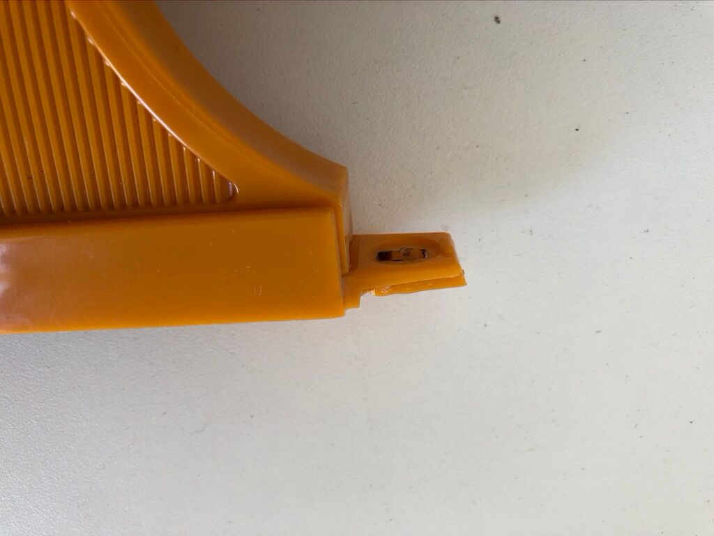 Tiltable orange plastic mirror with matching wall light