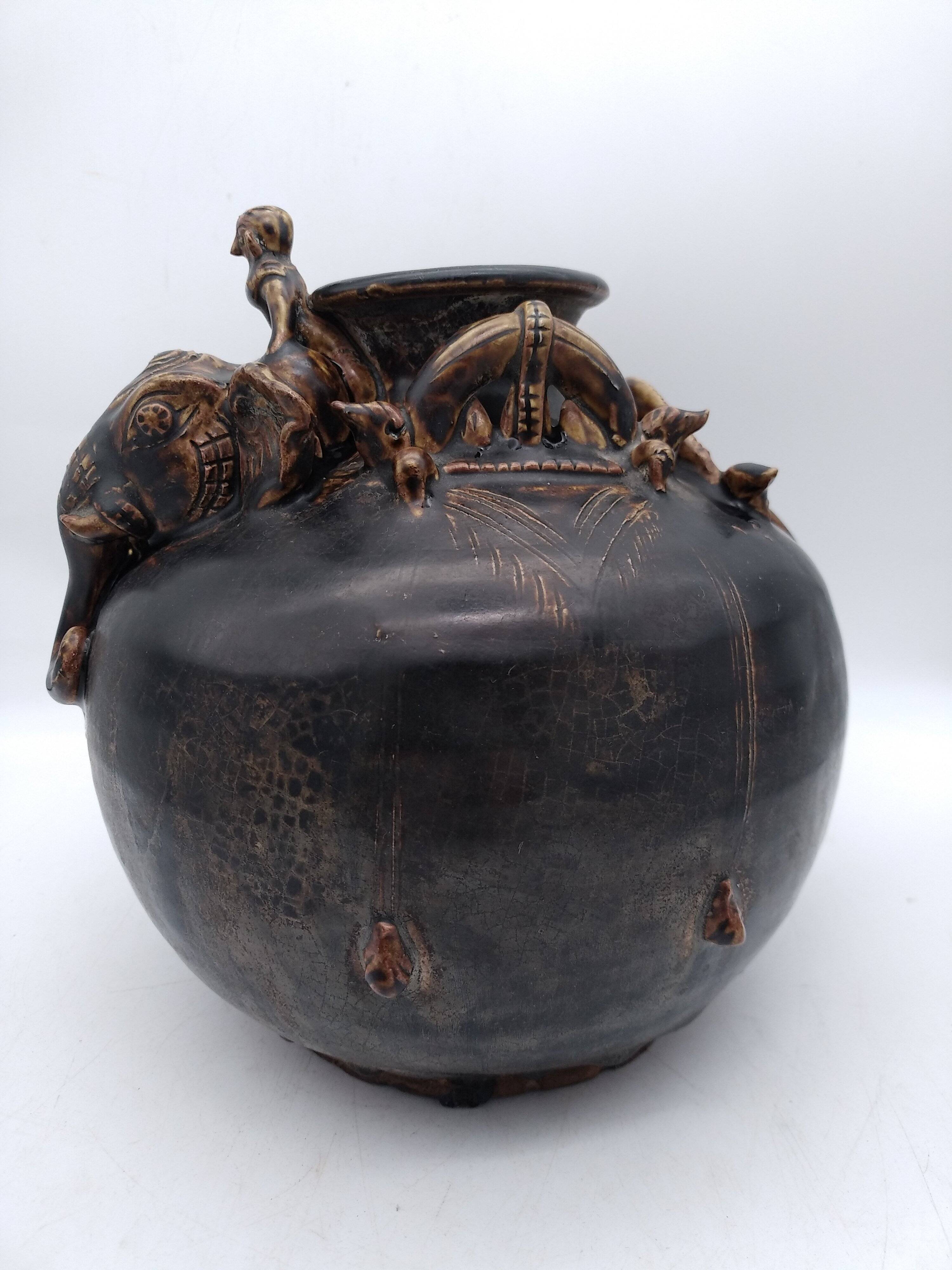 Antique Khmer ceramic vase. With elephant decoration.