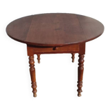 Old extendable round table in fruit wood with folding sides