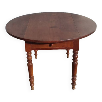 Old extendable round table in fruit wood with folding sides
