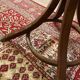 Antique curved wooden coat rack with umbrella stand.