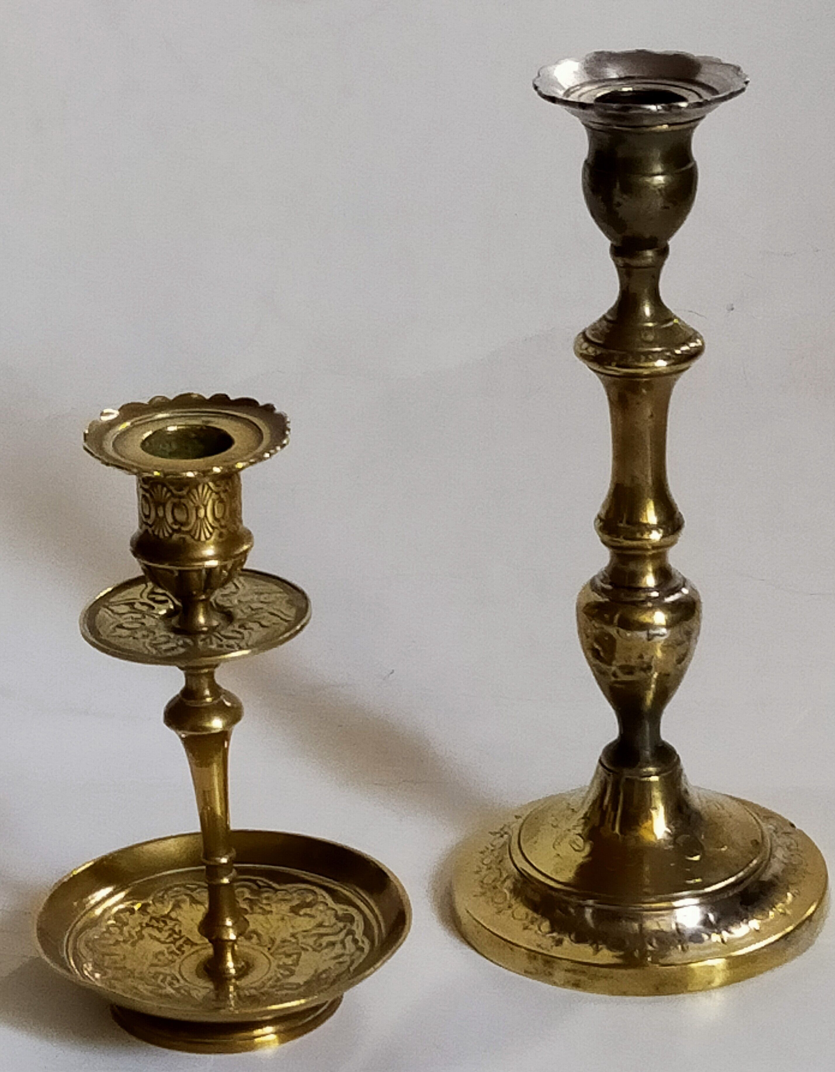 Duo of solid brass and gold metal candle holders worked old