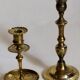 Duo of solid brass and gold metal candle holders worked old