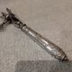 Silver metal handle in the style of Louis XVI.