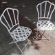 Antique garden furniture in solid wrought iron.