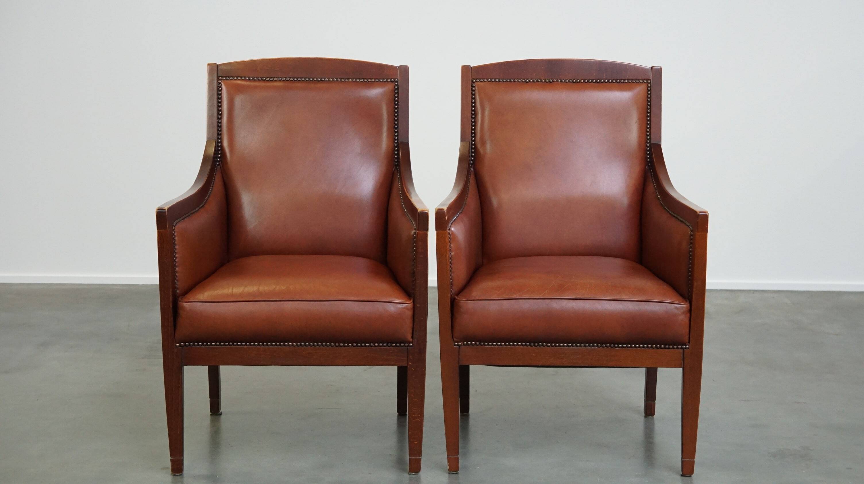 Set of 2 cognac-colored cowhide Art Deco design armchairs