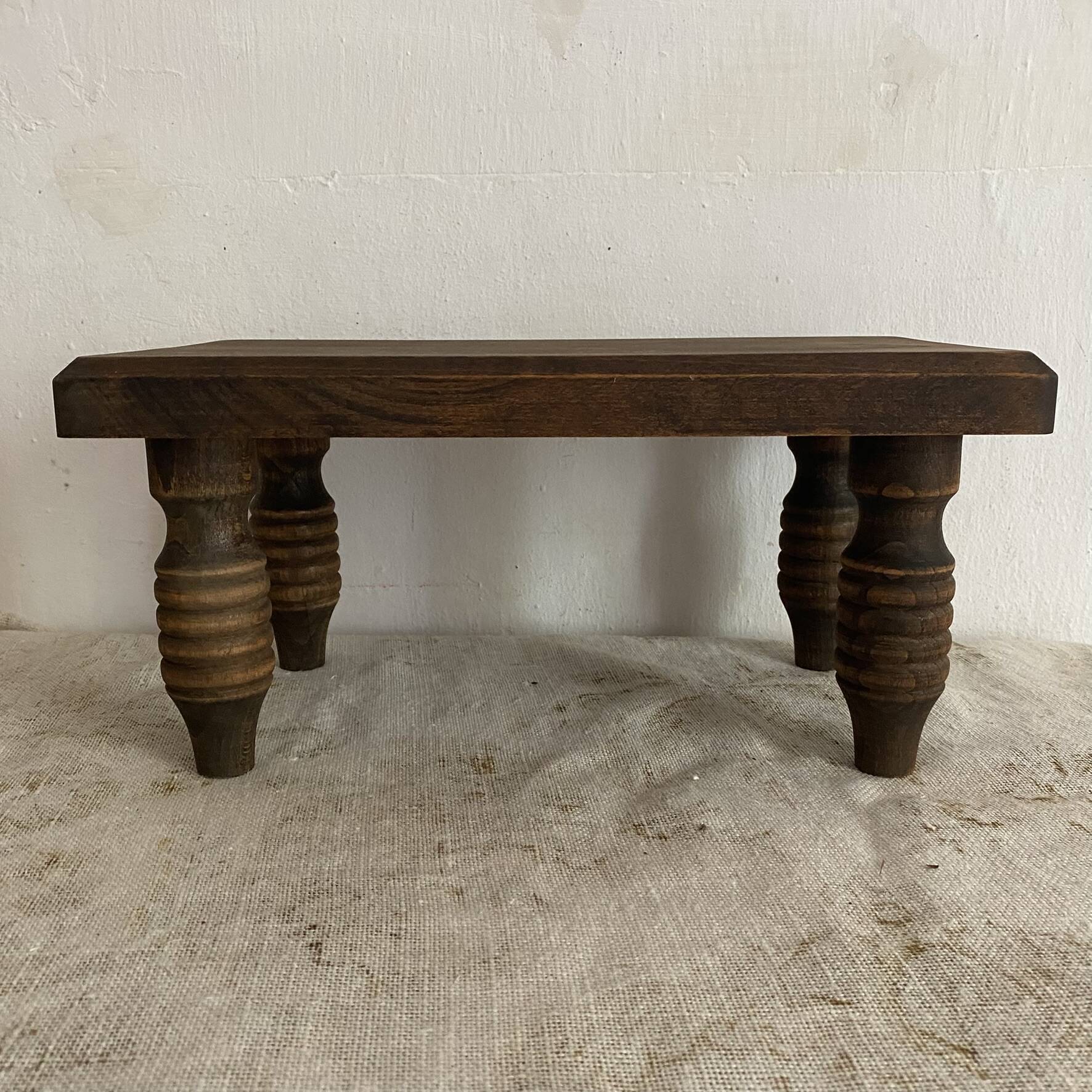 Low stool, turned wooden legs.
