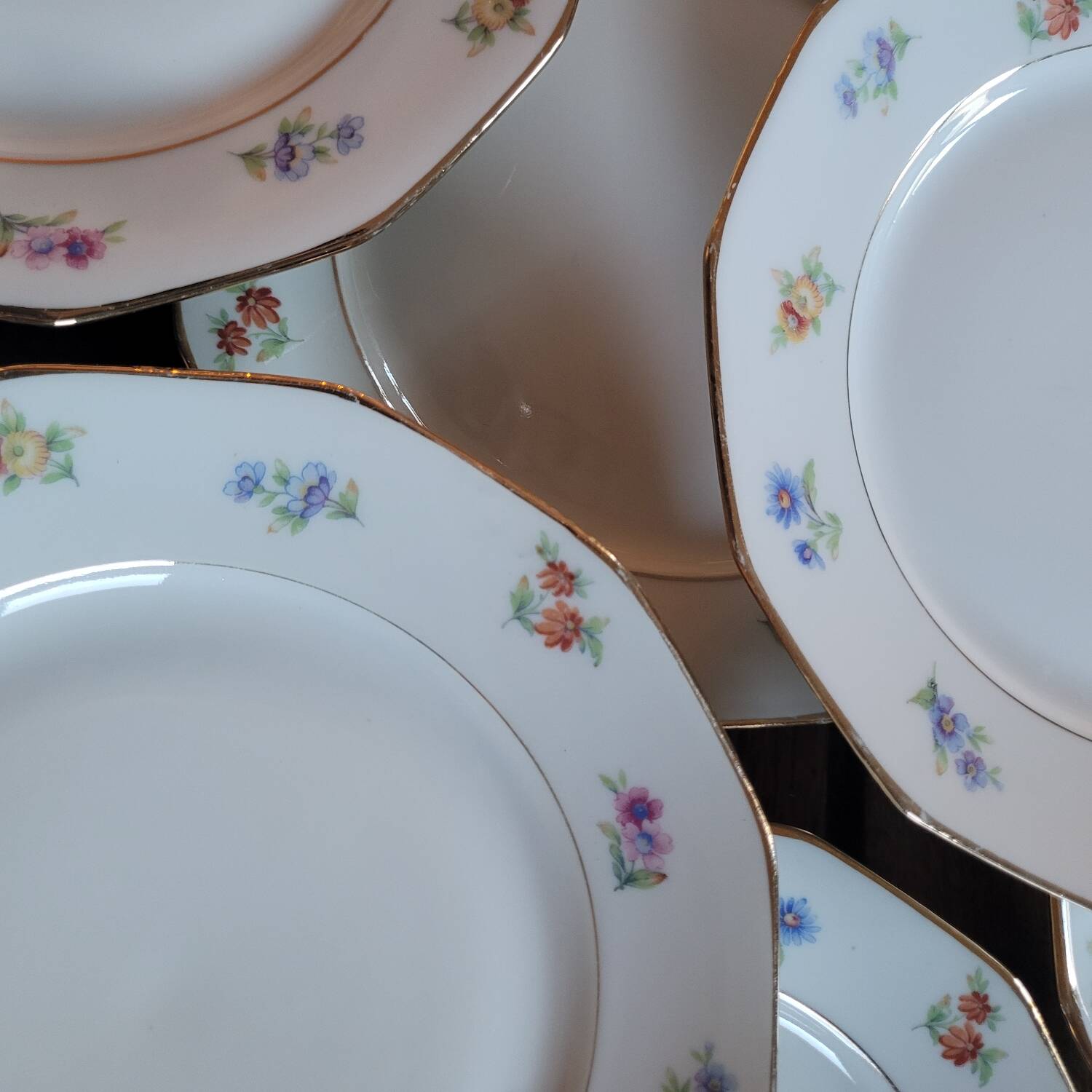 8 porcelain dessert plates with gold rim and various flowers
