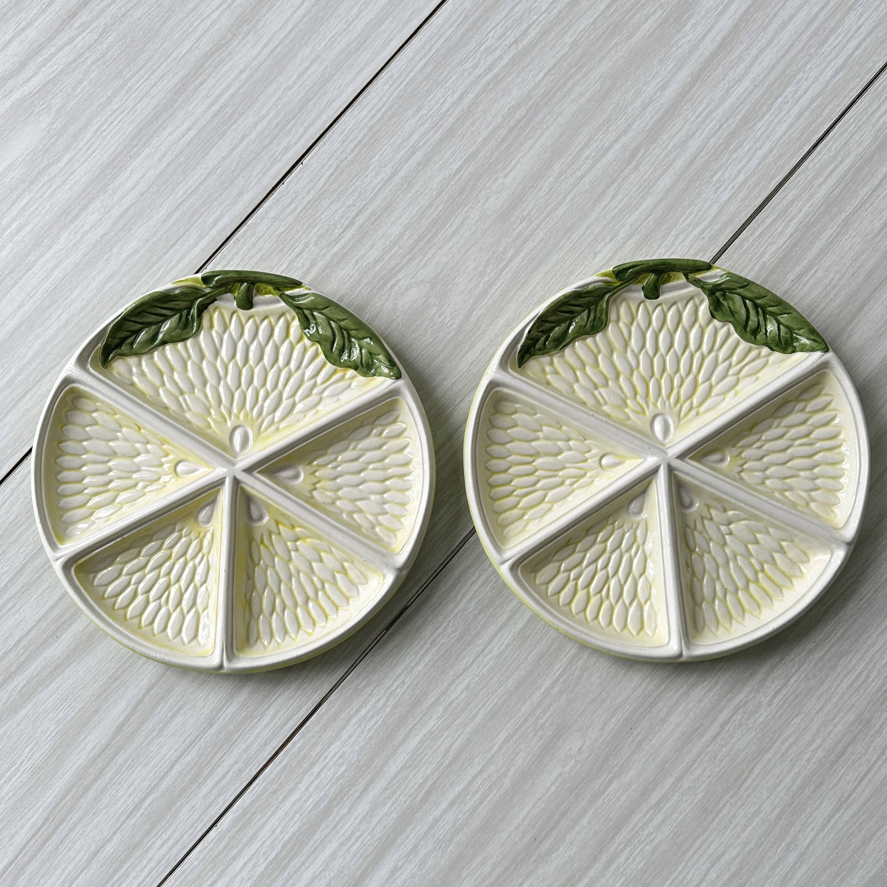 2 ceramic plates depicting a lemon