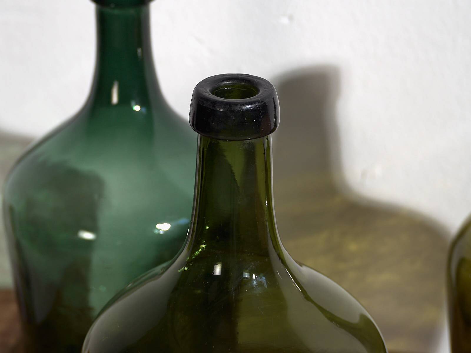 Antique green demijohns (circa 1920). Set of 3 pieces