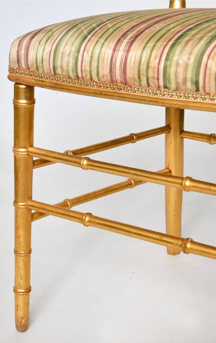 Pair of golden wood chairs in a bamboo style.