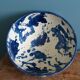Empty pocket bowl in terracotta, glazed with "ink spots" design.