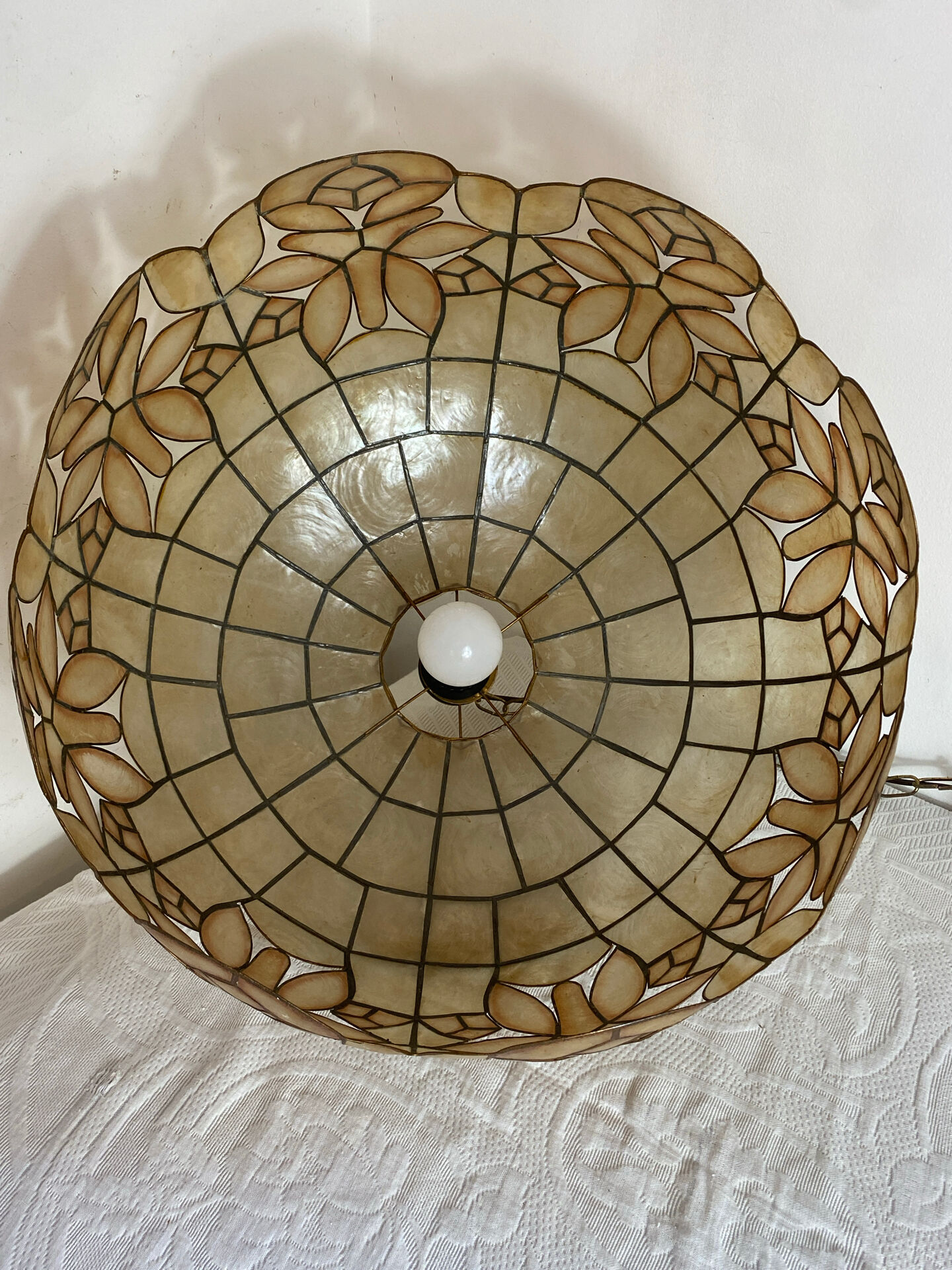 Large mother-of-pearl and brass chandelier with floral decoration.