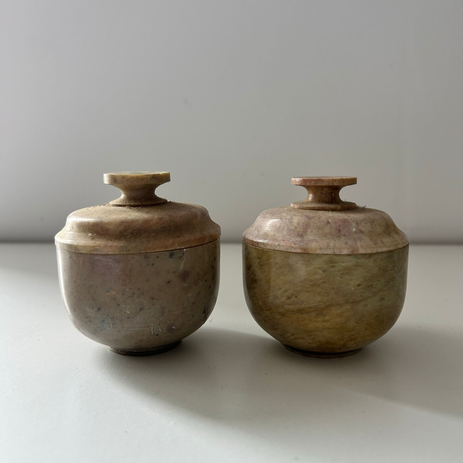 2 small stone urns
