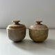 2 small stone urns