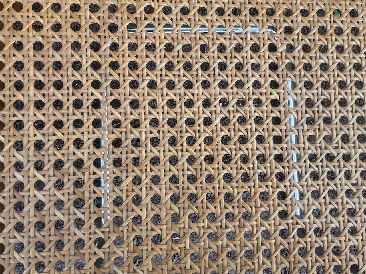 Wooden chair with caning in the style of Marcel Breuer.