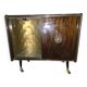 Vintage 50s-60s bar cabinet with tufted upholstery and lighting.
