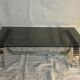 Vintage coffee table from the 70s in chrome and smoked glass, Space Age and Mid-Century style.