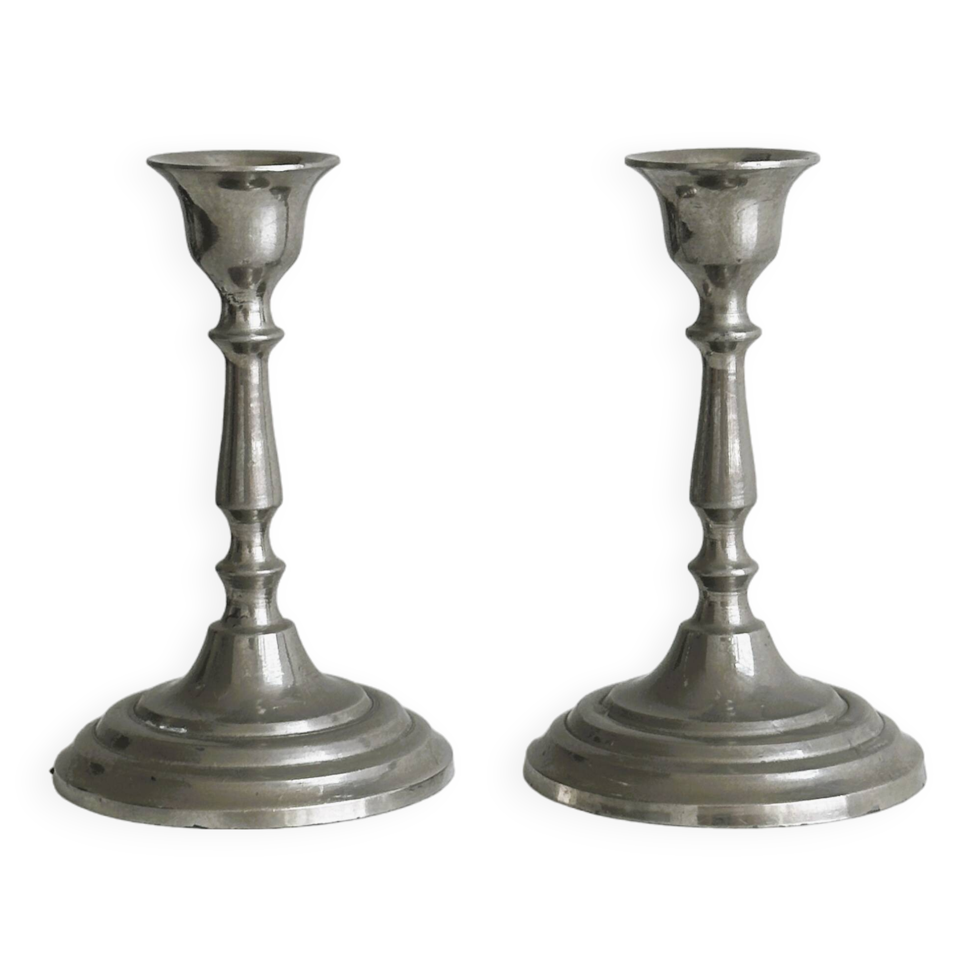 Pair of small metal candle holders, classic design.