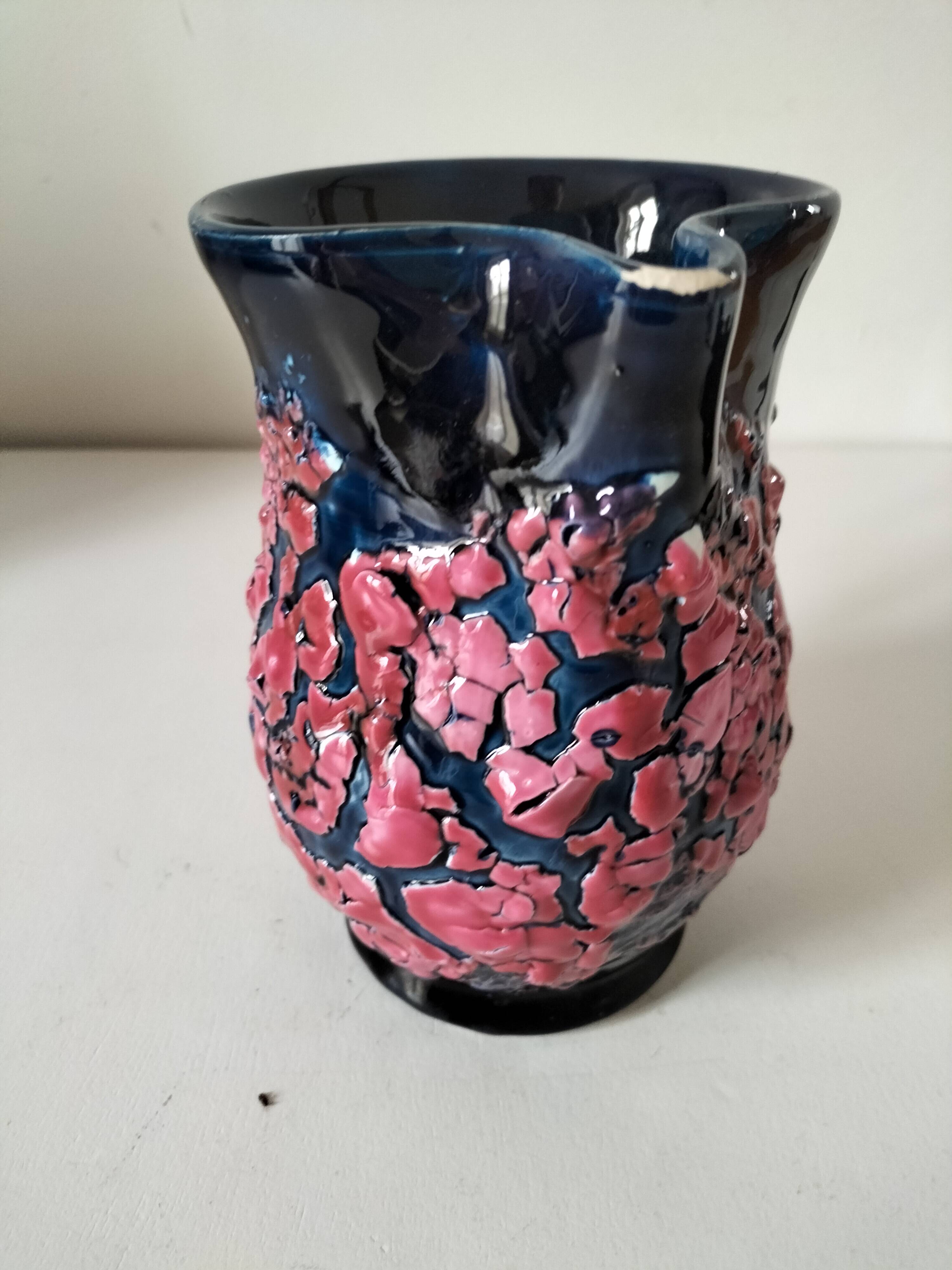 Vintage pitcher in midnight blue glazed ceramic with bright pink relief