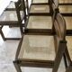 Set of 12 "sledge" dining chairs in walnut and cane.