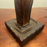 Old lamp with carved wooden base representing a wise man