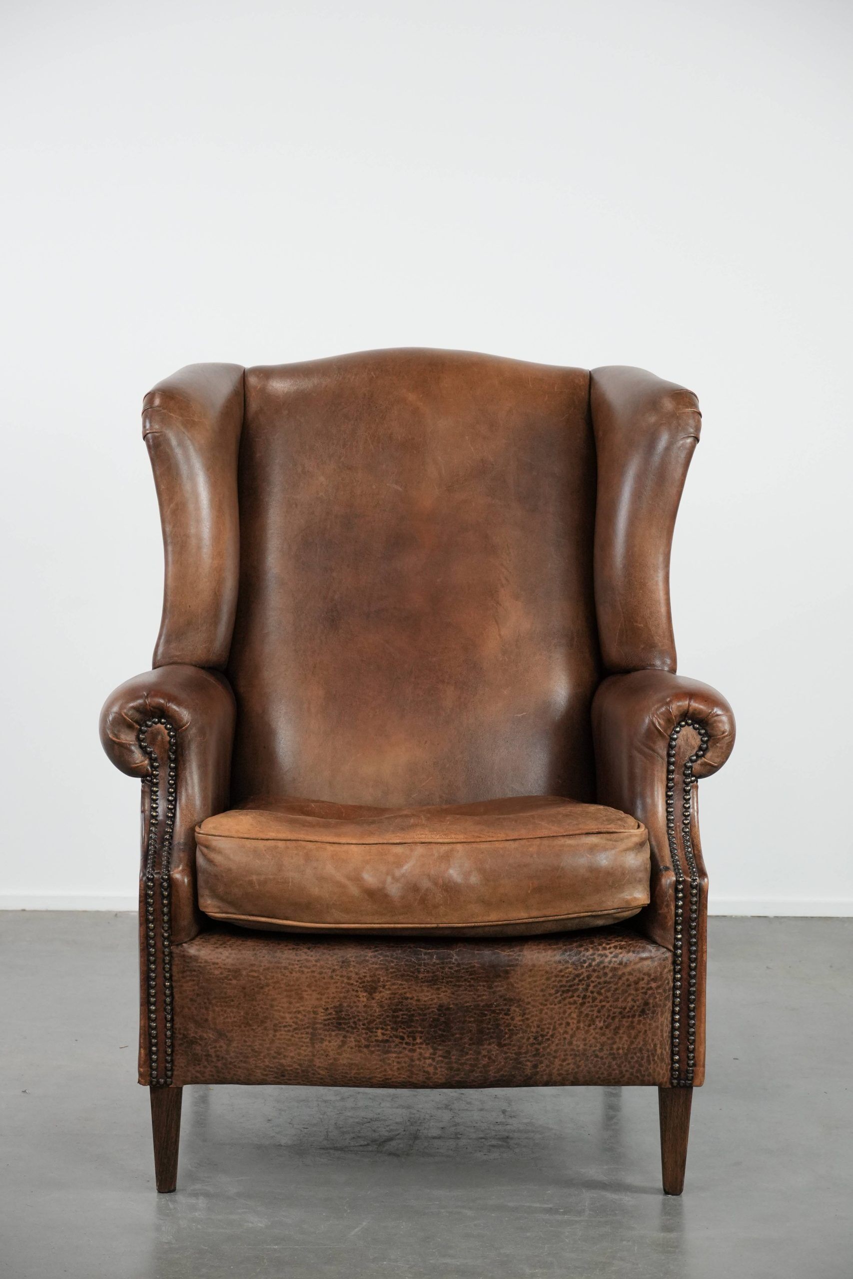 Warm, cosy and comfortable vintage sheepskin ear armchair with character