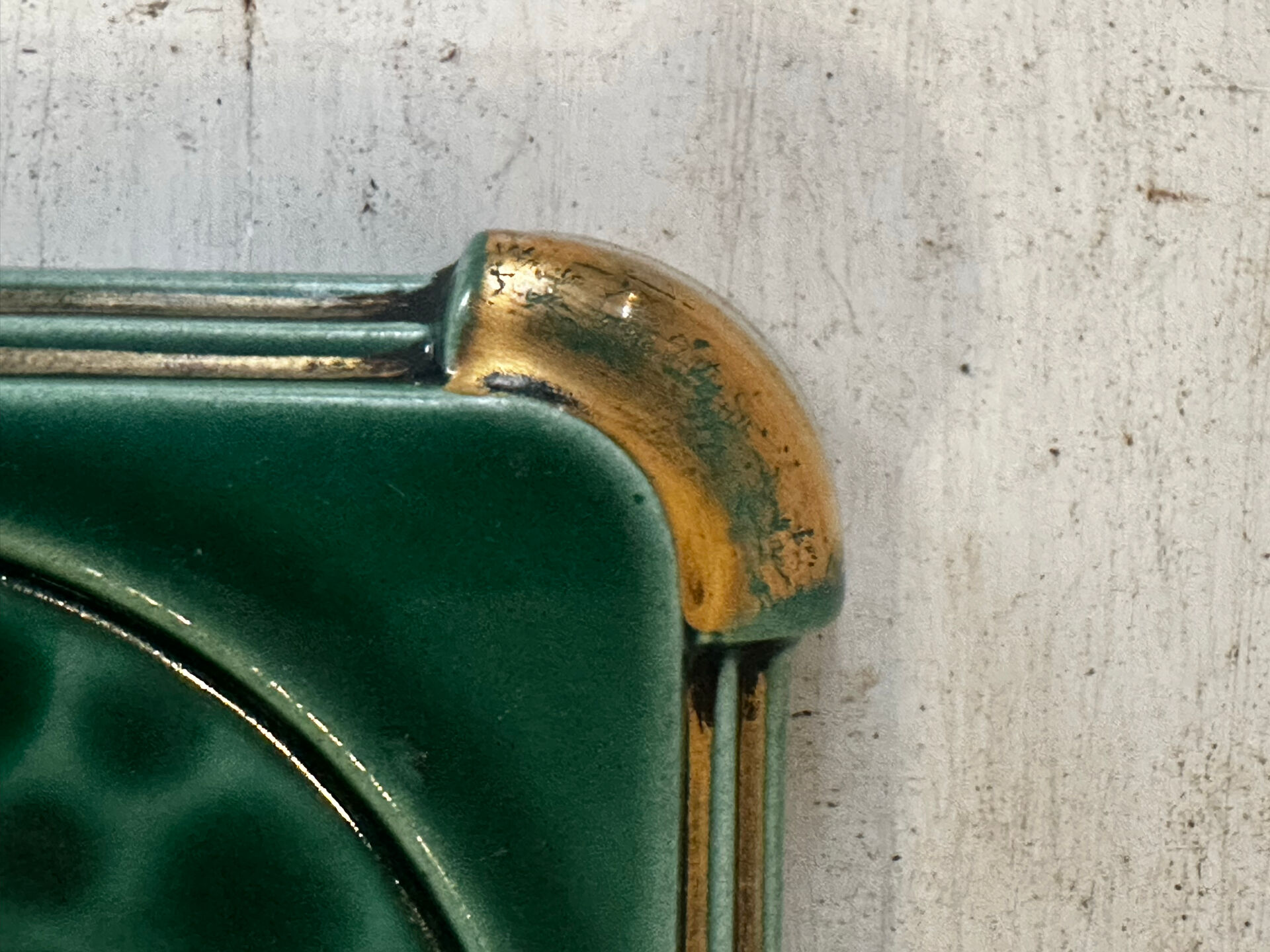 Art Deco bottle coaster in speckled green glazed ceramic and