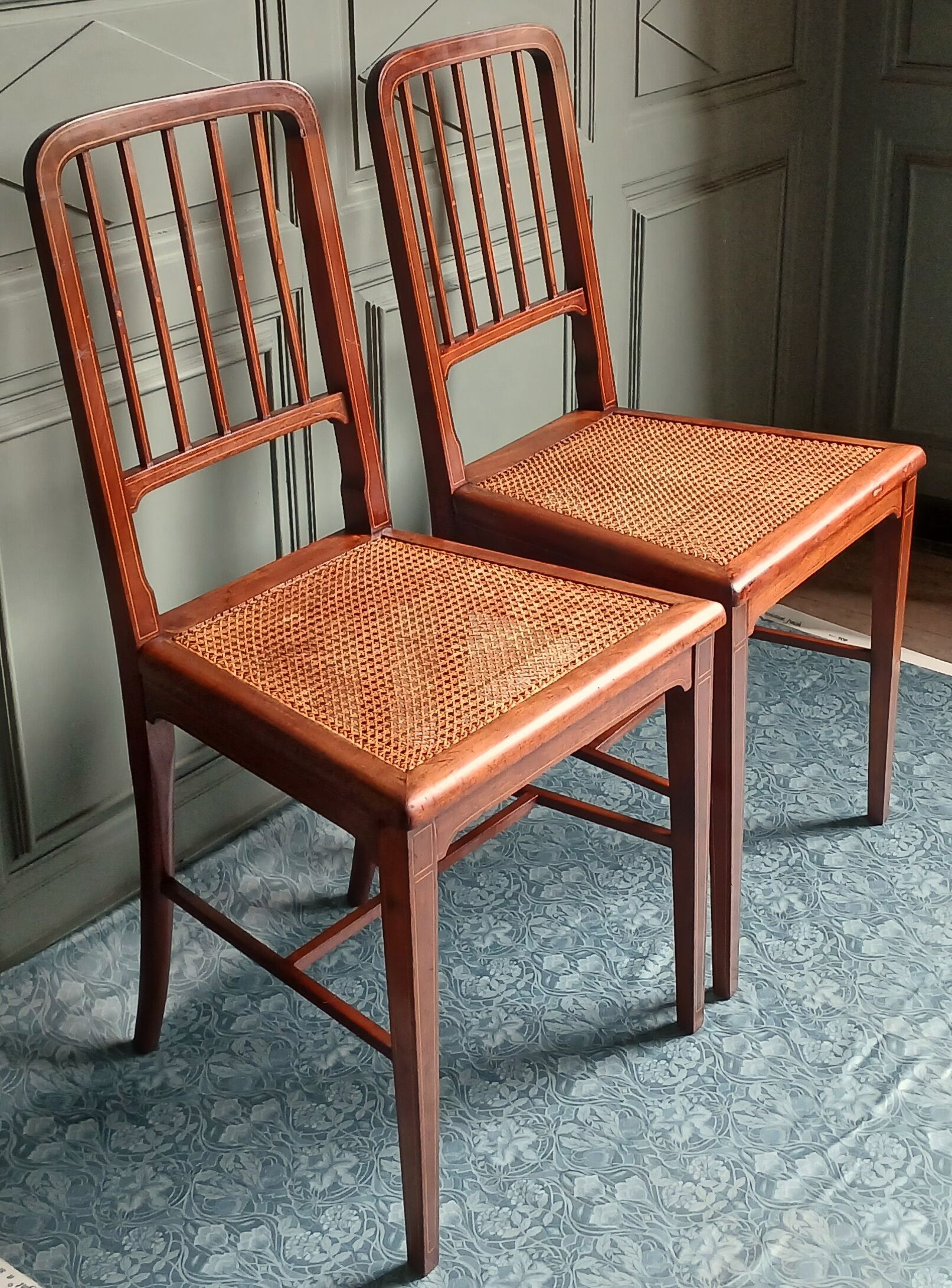 Pair of caned mahogany chairs, circa 1930.