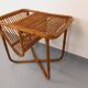 Side table / coffee table with vintage 1960s rattan magazine rack.