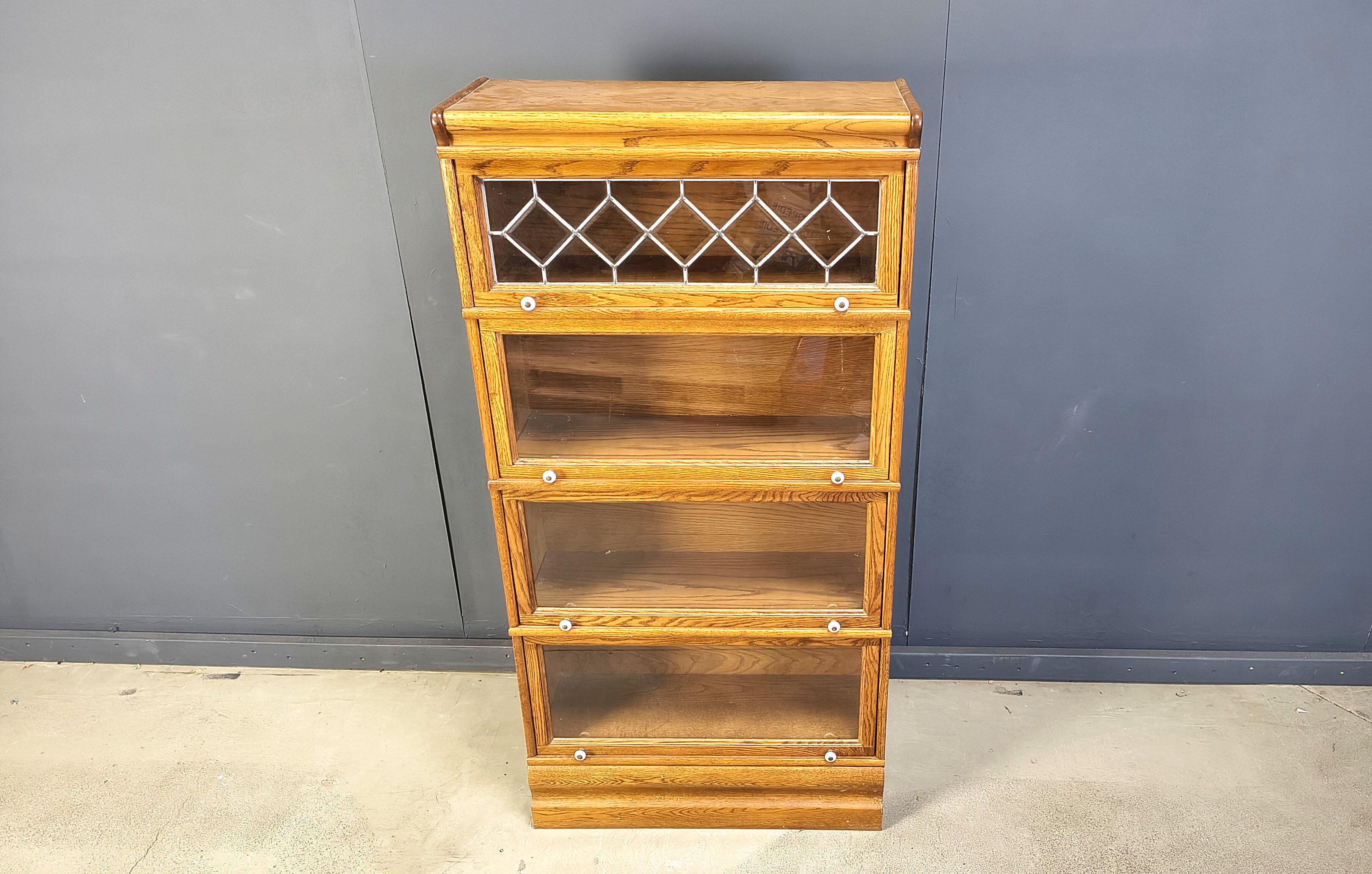 Four tier oak barrister style bookcase with leaded glass
