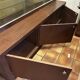 Vintage wooden and glass display cabinet, 15 shelves, gold background.