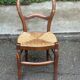 Vintage solid oak chair with rush seat, Louis Philippe style from the 20th century.