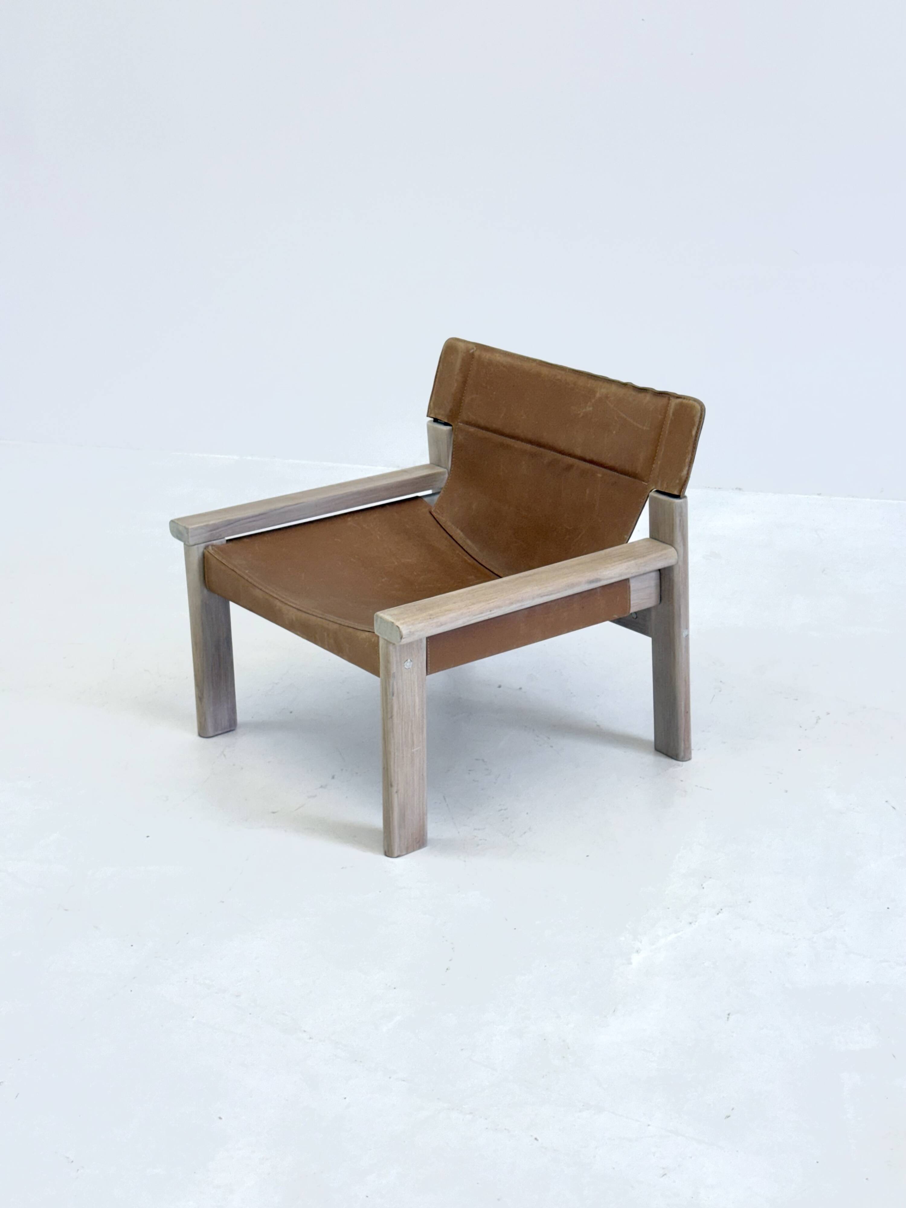 Stylish vintage armchair with saddle leather seat
