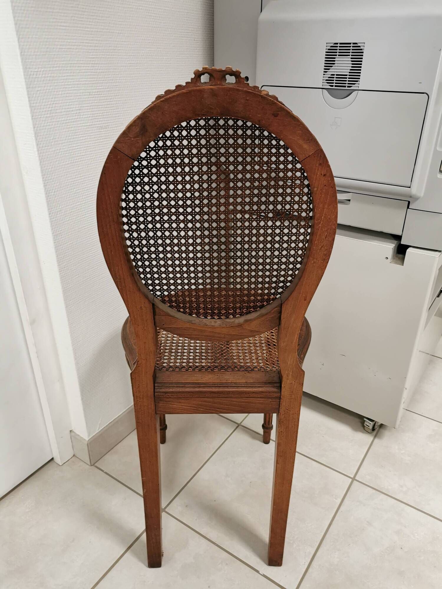 Antique chair Louis XVI style, seat caned, carved wood