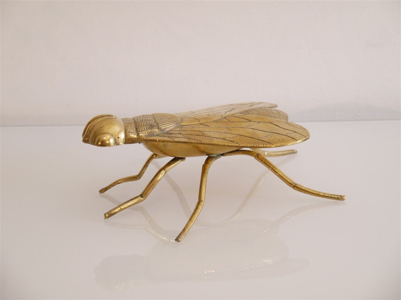 Empty vintage pocket in the shape of a brass insect