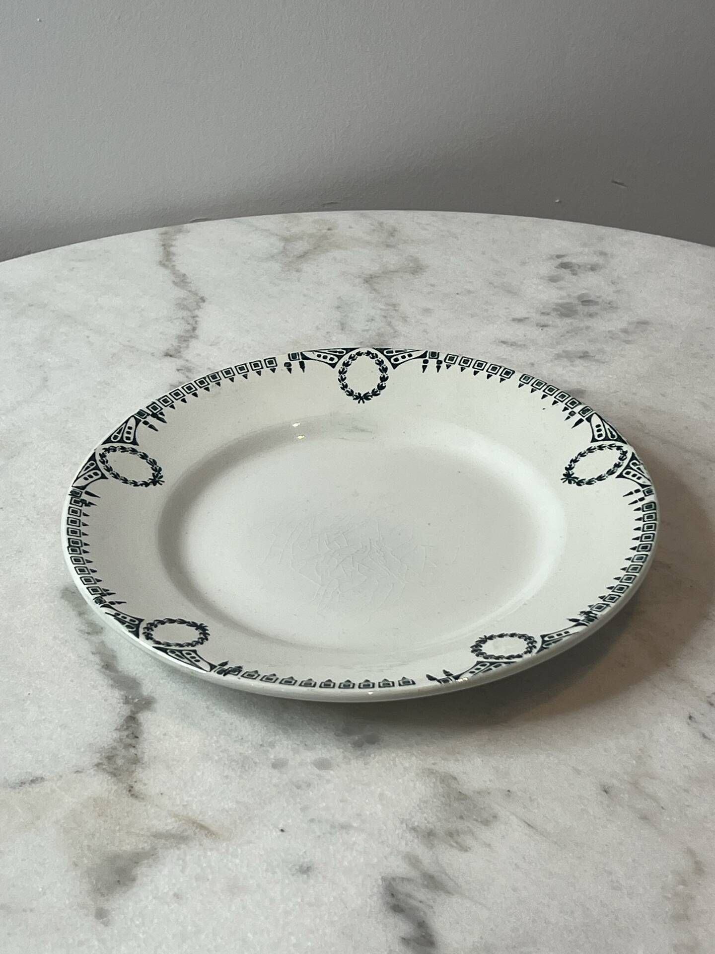 Set of 2 Saint Amand plates with laurel crown decoration.