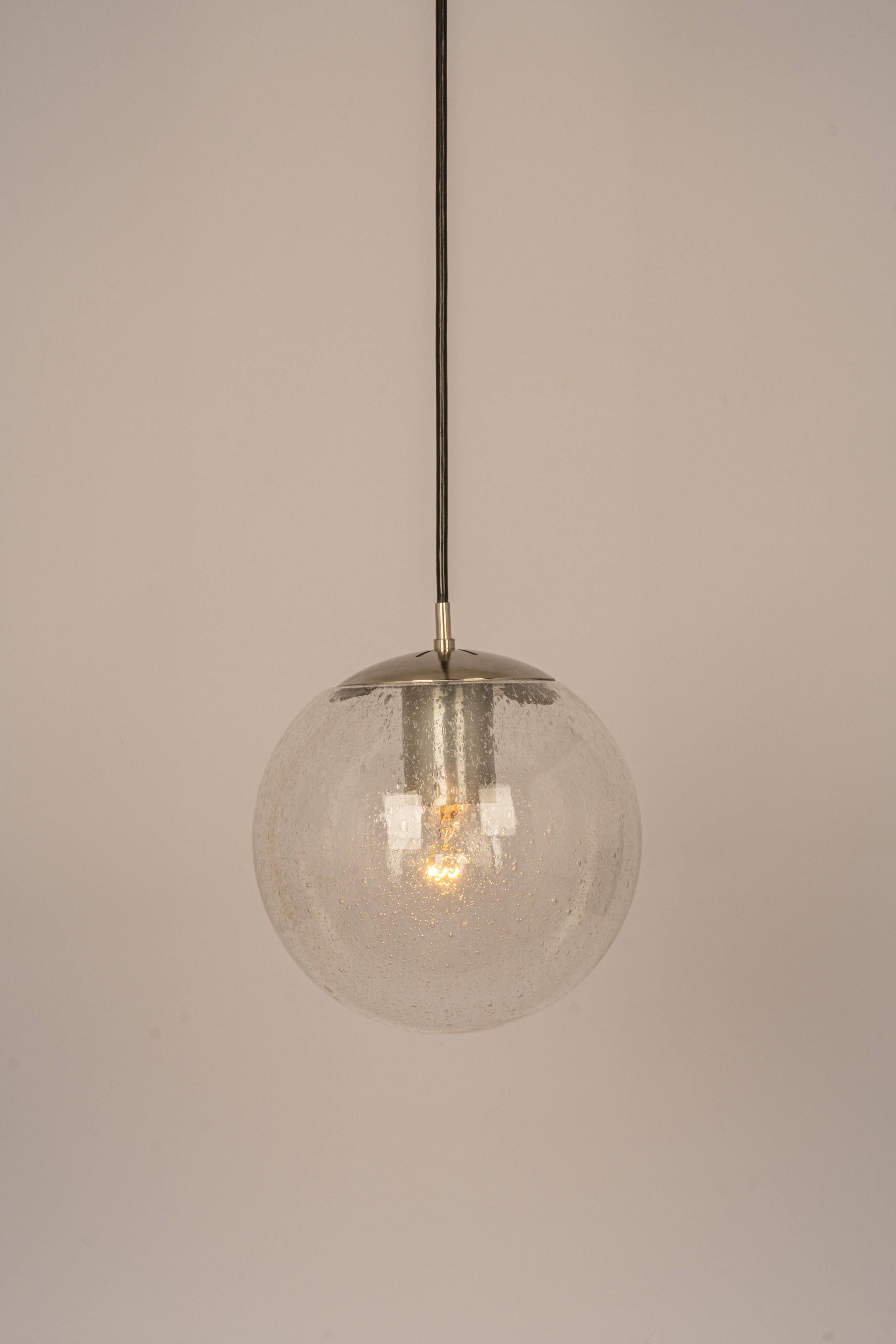 Small Limburg chrome pendant light with transparent glass ball, Germany, 1970s.