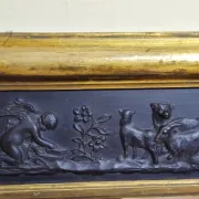 Large antique gilded wooden mirror with terracotta relief from the Empire period.