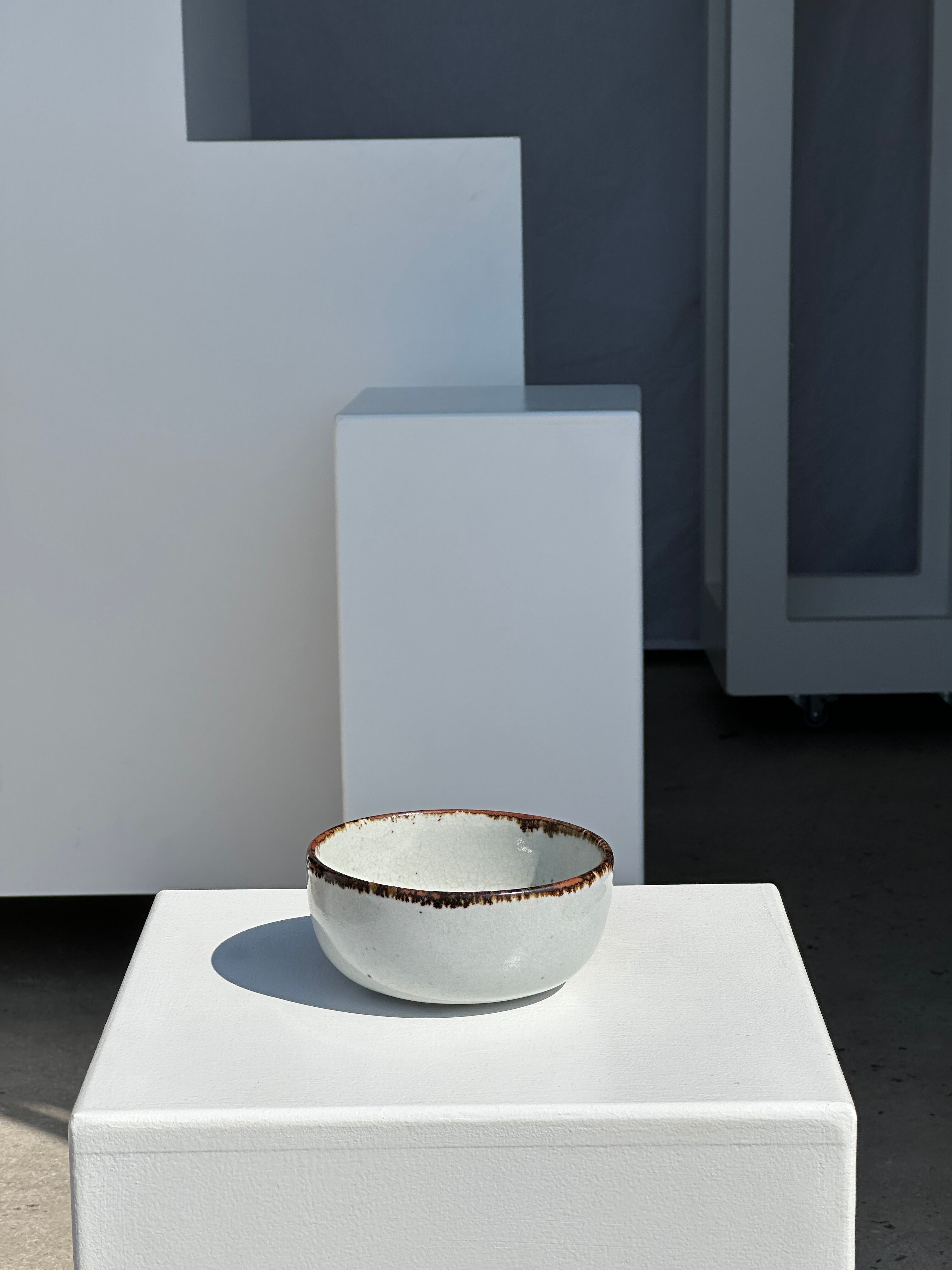 Small white glazed ceramic bowl black edges