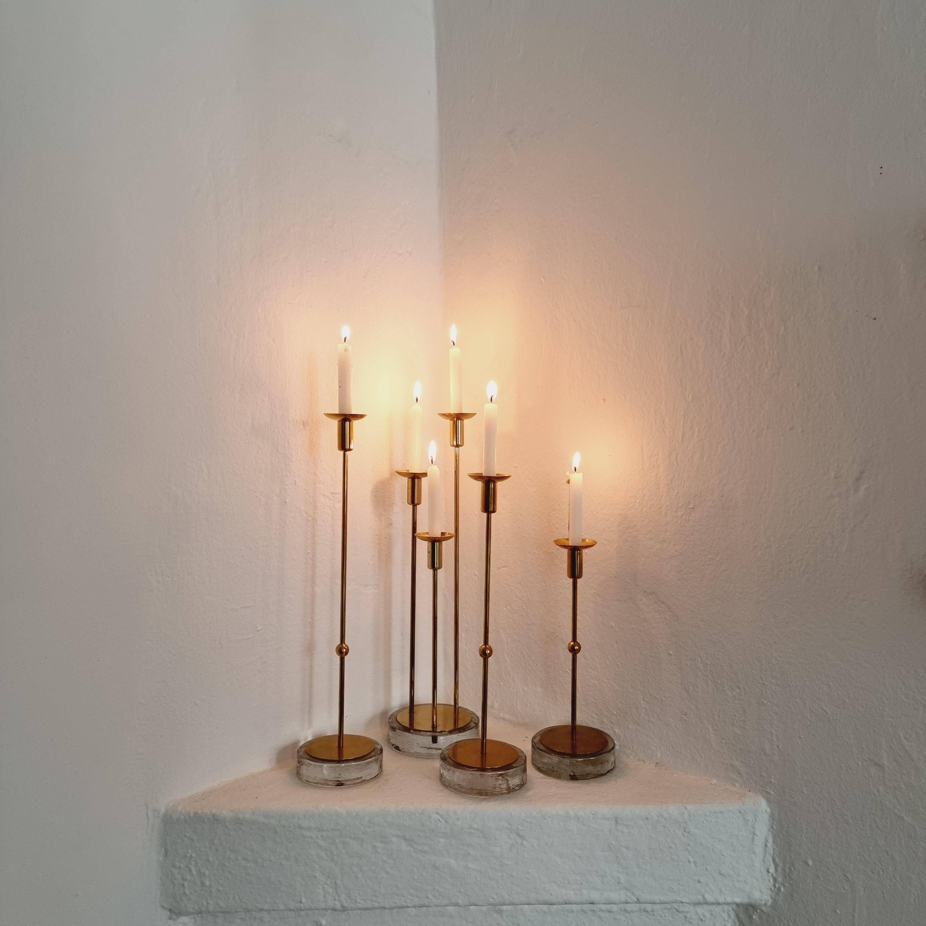 Gunnar Ander, four candlesticks, brass and glass, Ystad Metall, Swedish modern.