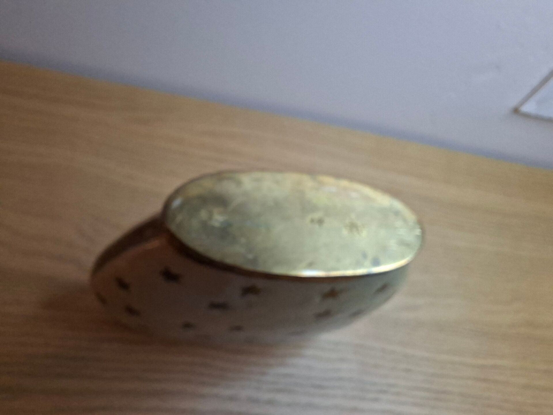 Small vintage soliflore vase in white enamelled brass with golden stars.