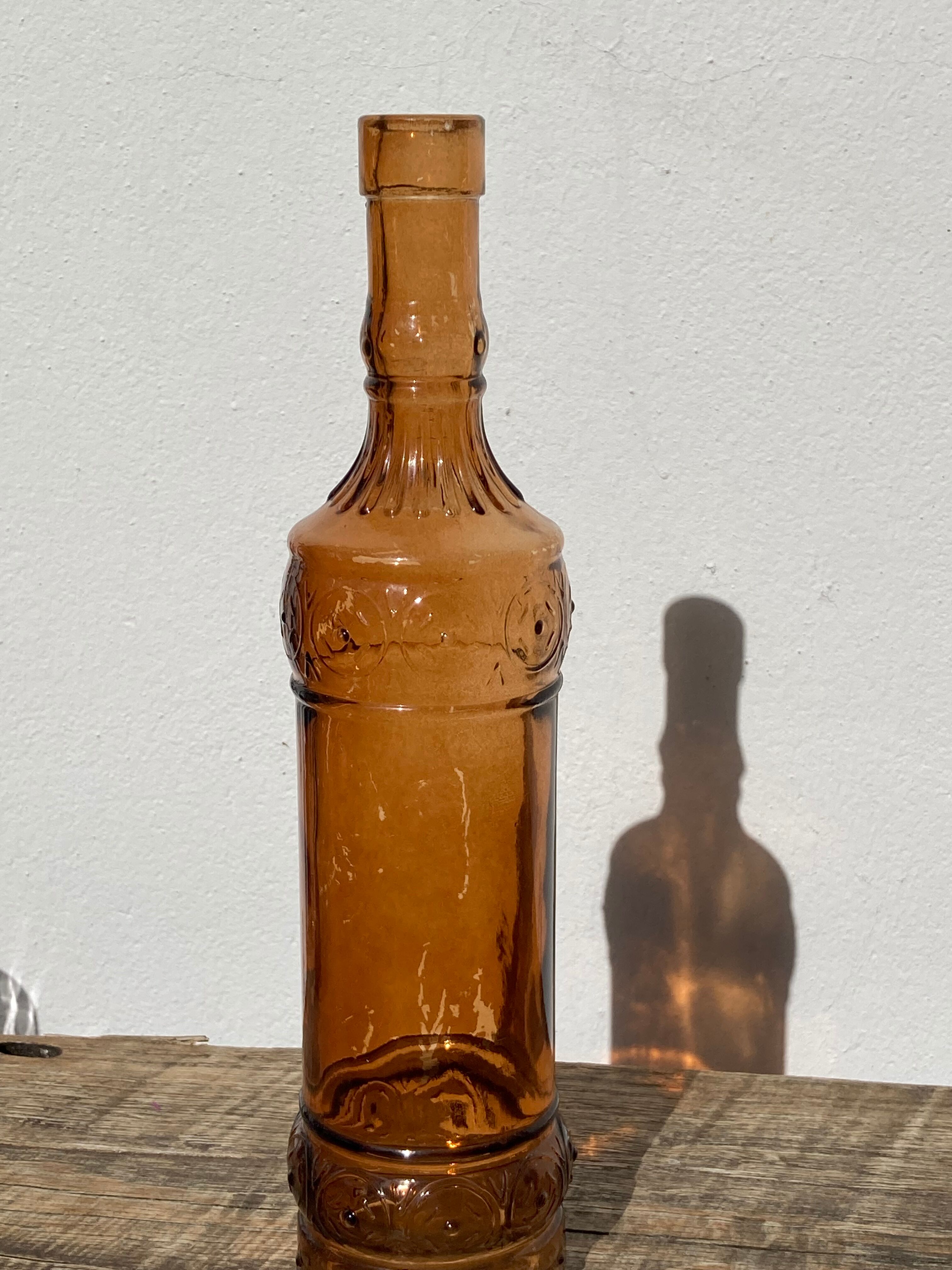 Vintage amber bottle in patterned brown glass
