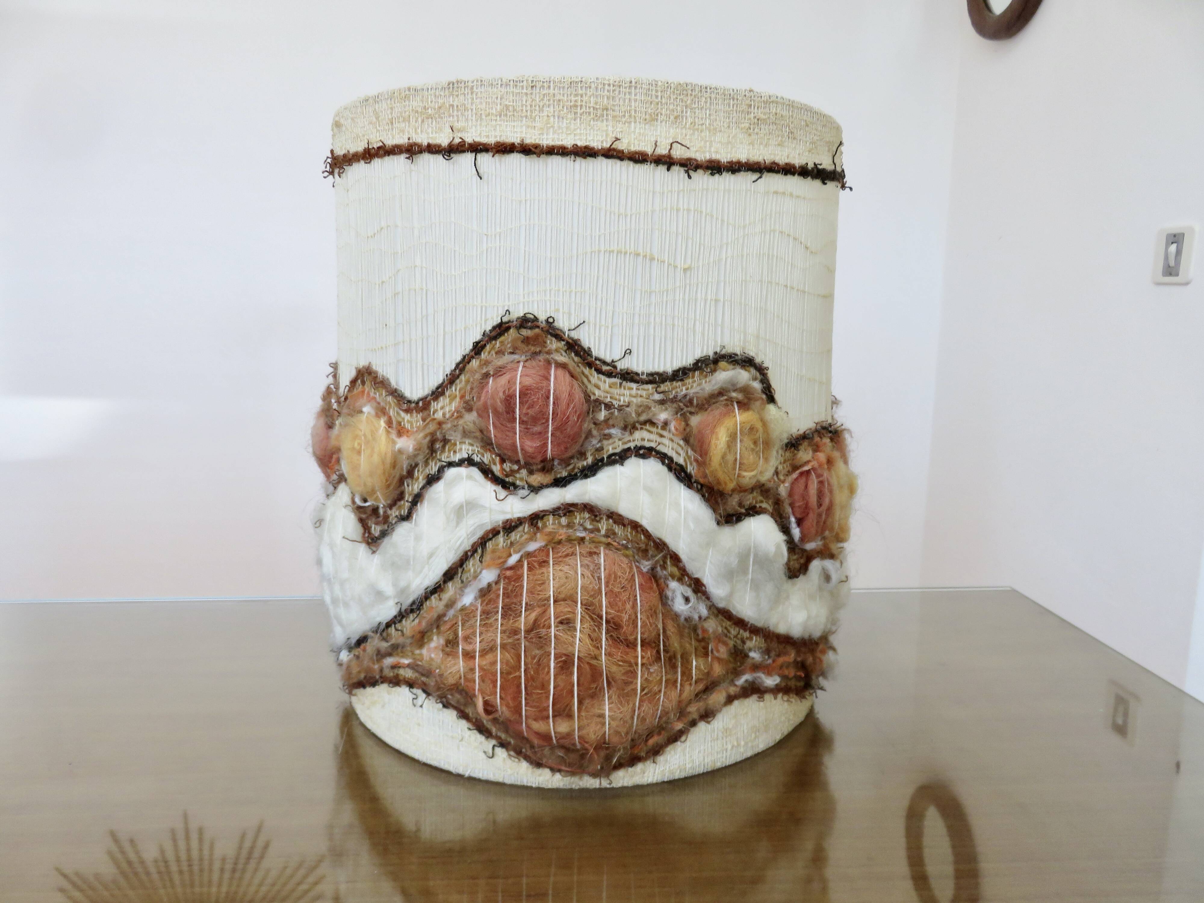 Ceramic lamp with double lighting and openwork design.